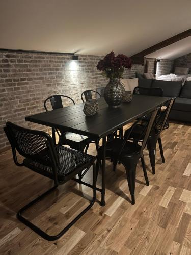 a black dining table and chairs in a living room at Spirit Bed & Breakfast in Ekeby