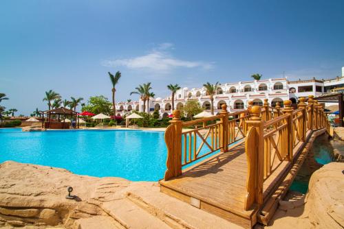 a bridge over a swimming pool at a resort at Savoy Sharm El Sheikh in Sharm El Sheikh