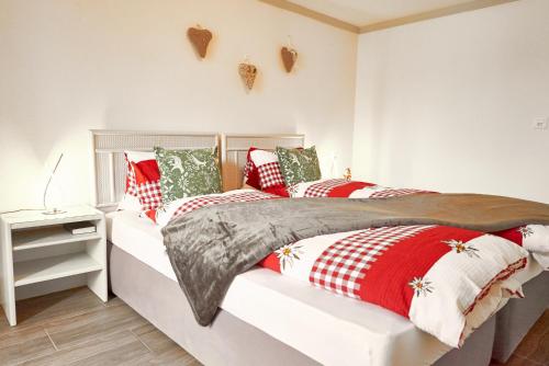 a bedroom with a bed with red and white pillows at Double Room by Interlaken. Parking in Därligen