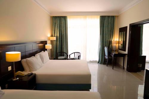 a hotel room with a bed and a window at Sierra Sharm El Sheikh in Sharm El Sheikh