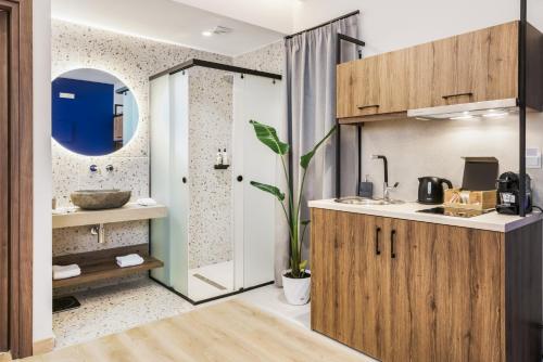 a bathroom with a sink and a mirror at Princess of Axos Luxury Suites in Axós