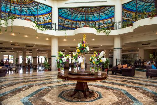a large lobby with a table with flowers on it at Grand Oasis Resort in Sharm El Sheikh