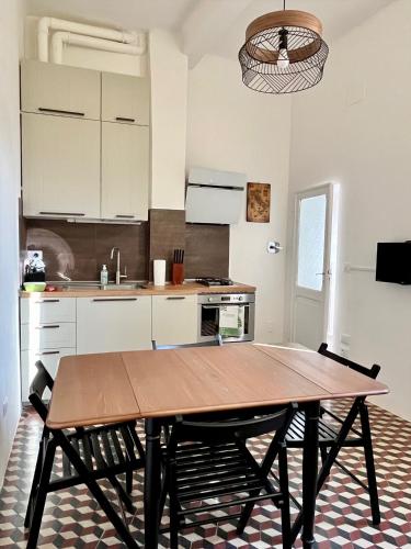 een keuken met een houten tafel in een kamer bij Appartamento Mascarella 19 in Bologna