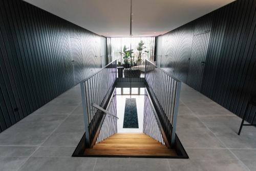 a staircase in a building with a room with a window at Exklusive Design Appartement Magnolia Neubau in Pfungstadt
