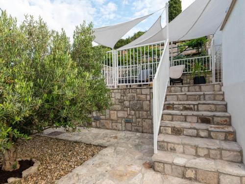 a stairway with a white tent and some bushes at Holiday Home Lea in Maslinica