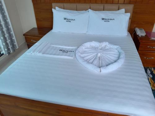 a bed with a heart made out of towels at WILIVINA HOTEL in Dar es Salaam