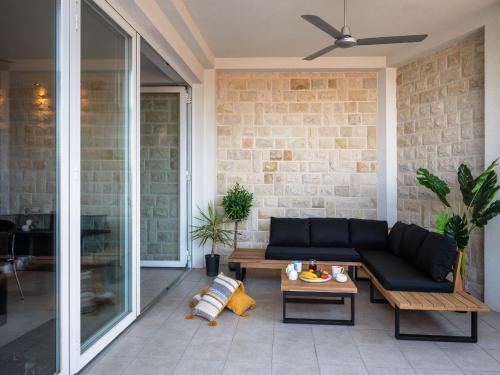 a living room with a couch and a table at Holiday Home Lea in Maslinica