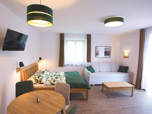 a living room with a couch and a table at Apartmány Lipno-Hory in Horní Planá