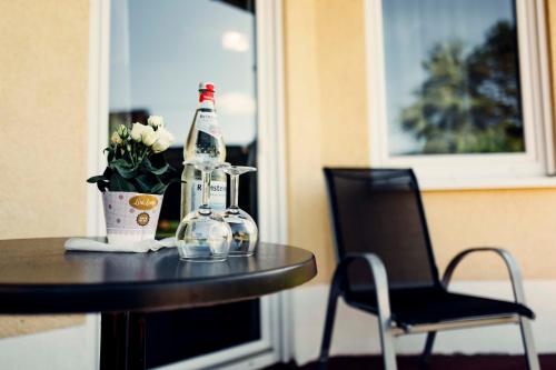 a table with a bottle and a chair at Gästehaus Windhagen in Windhagen