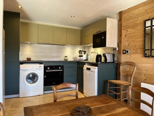 a kitchen with a washing machine and a washer at Chalet Les Pierres Sauvages in Saint-Sorlin-dʼArves