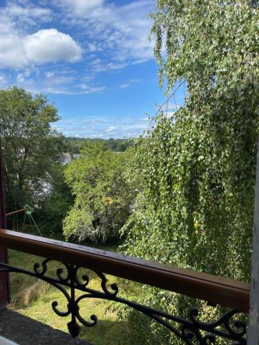 a balcony with a view of trees and bushes at Le Château Giat in Giat