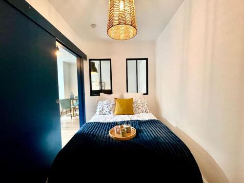 a bedroom with a bed with a tray on it at Magnifique Appartement Hypercentre - Le Charly in Pau