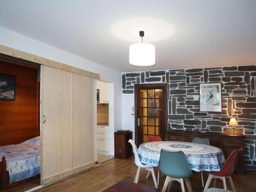 een kamer met een tafel en stoelen en een stenen muur bij Appartement Les Orres, 2 pièces, 6 personnes - FR-1-322-568 in Les Orres