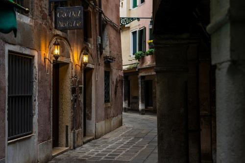 an empty alley in an old town with buildings at Ca' Del Nobile in Venice