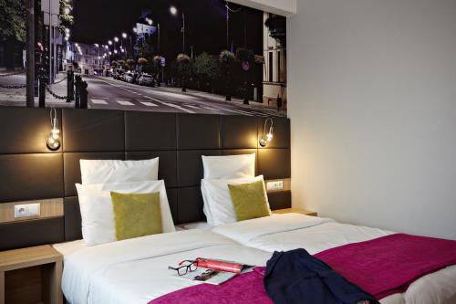 Кровать или кровати в номере Vestil Hotel