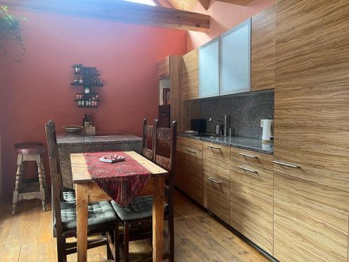 a kitchen with a wooden table with a red wall at Casa Viola in Piano