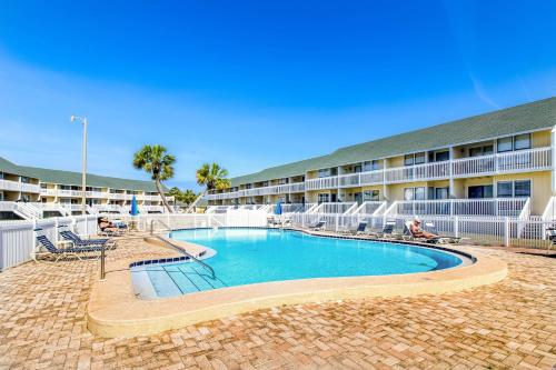 a swimming pool in front of a hotel at ​Sandpiper cove in Destin