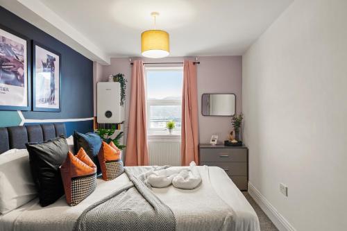 a bedroom with a large bed with a window at Beautiful Duplex with Private Rooftop - Sleeps 6 in Bristol