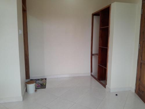 a room with a white wall and a door at WILIVINA HOTEL in Dar es Salaam