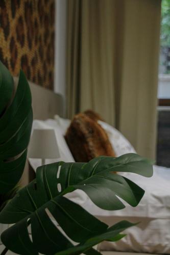 a leafy plant sitting on a bed with a banana at VillaTonia - Suite home in Molfetta