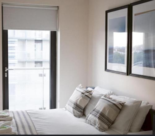una camera da letto con letto, cuscini e finestra di Water view harbour a Glasgow