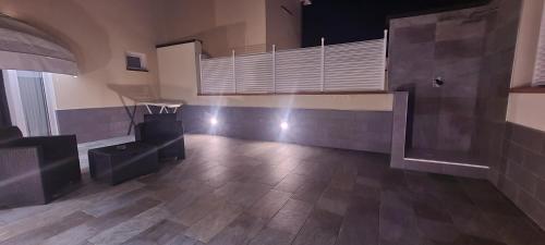 a large empty room with a table and a staircase at Villa Nasti Luxury Bed Taurasi Room in Nocera Inferiore