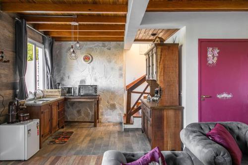 Il comprend un salon avec une porte violette et une cuisine. dans l'établissement Schatz Chalé Witmarsum, à Palmeira