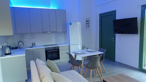 a kitchen with a couch and a table with chairs at MILIASIA in Kondáraina