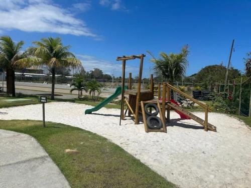 a park with a playground with a slide at Apt 1/4 novo, ambiente aconchegante na Praia do Forte. in Mata de Sao Joao
