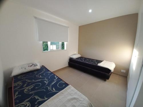 En eller flere senge i et værelse på soma departamentos