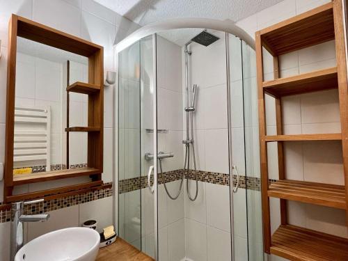 a glass shower in a bathroom with a sink at Appartement Huez, 2 pièces, 5 personnes - FR-1-405-346 in LʼHuez