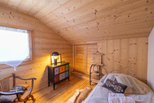 a bedroom with a bed in a log cabin at Le Solli in Saint-Gervais-les-Bains