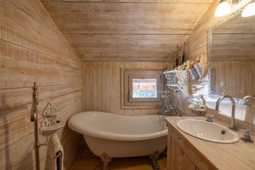 a bathroom with a tub and a sink at Le Solli in Saint-Gervais-les-Bains