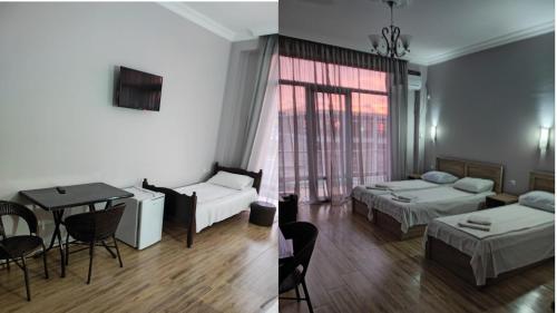 um quarto de hotel com duas camas e uma mesa e um quarto em FRESH Hotel Kobuleti em Kobuleti