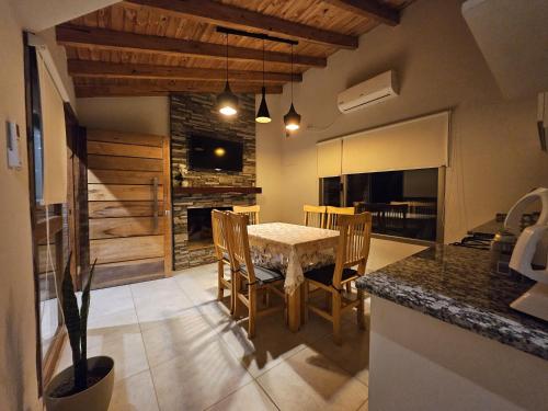 a kitchen with a table and chairs in a room at Cabañas Golden in San Rafael