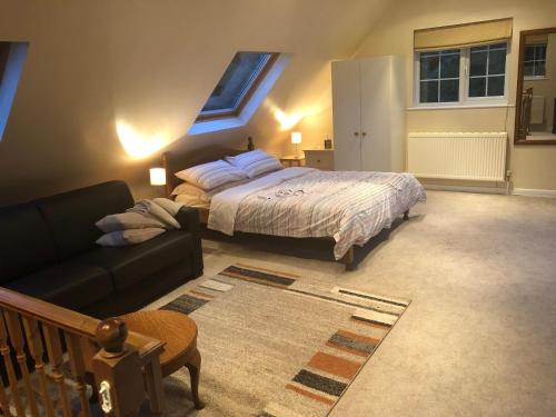 a bedroom with a bed and a couch at Burraton Cob in Exeter