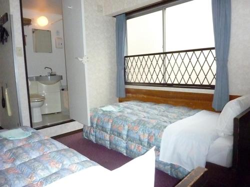 Cama o camas de una habitación en Otsuka City Hotel
