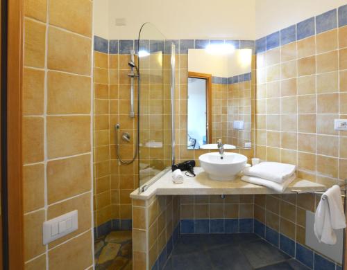 a bathroom with a sink and a shower at Sa Tirìa in Chia