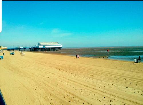 a view of a beach with a pier and the ocean at Sea view Apartment Sandy Toes and Salty Kisses Sleeps upto 4 in Cleethorpes