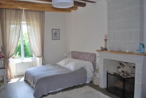 Ένα ή περισσότερα κρεβάτια σε δωμάτιο στο La Petite Boire - Chambres d'hôtes