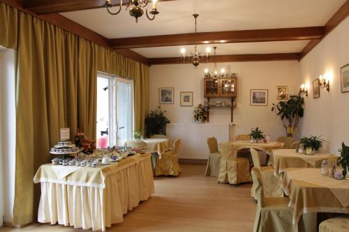 a room with tables and chairs and a large window at Haus Riedl in Seeboden