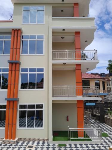 an exterior view of a building with orange columns at WILIVINA HOTEL in Dar es Salaam