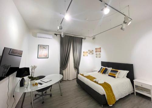 a bedroom with a bed and a table and a desk at Termini Rita House in Rome