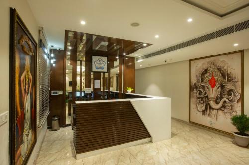 a lobby with a bar with a painting on the wall at Eastlynn Resort Rishikesh in Rishīkesh