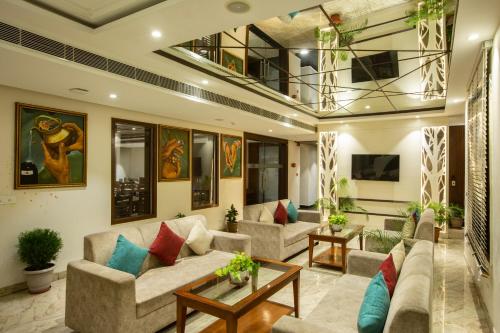 a living room with couches and a table at Eastlynn Resort Rishikesh in Rishīkesh