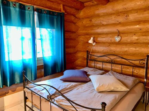 1 dormitorio con 1 cama en una cabaña de madera en Le Gite de Briey en Chalais