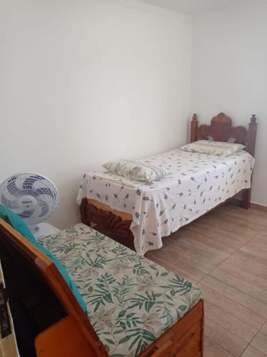 En eller flere senger på et rom på Casa aconchegante - Localizada à 300 metros do Forrogaço