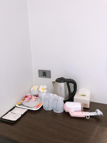 a counter with a tea kettle and other kitchen items at Lanta Daisy Residence in Ko Lanta