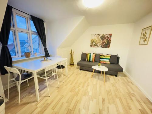 a living room with a table and a couch at aday - Randers Elegant and Trendy Apartment in Randers