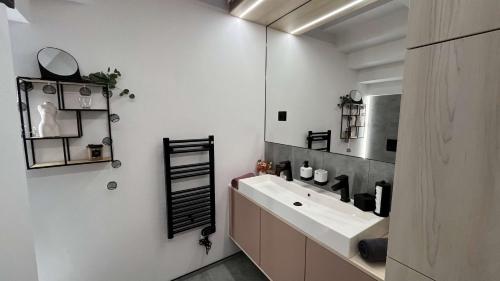 a bathroom with a sink and a mirror at apartmanhrabovob14 in Ružomberok